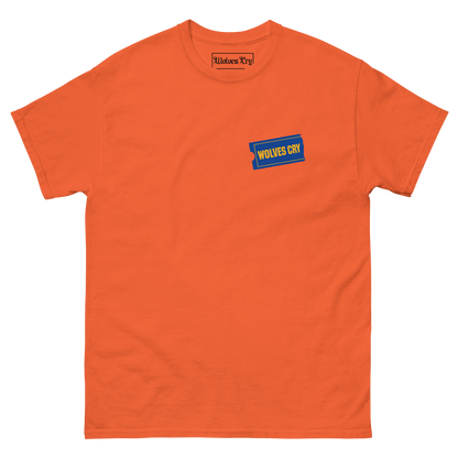 An orange crewneck t-shirt with a small blue and yellow graphic on the left chest that reads 'WOLVES CRY'. The brand name 'Wolves Cry' is also visible on the inner neck label.
