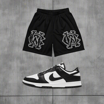 Model wearing Wolves Cry Originals OG Mesh Shorts Black & White Classic Edition, styled for a bold streetwear look with versatile and sustainable performance.