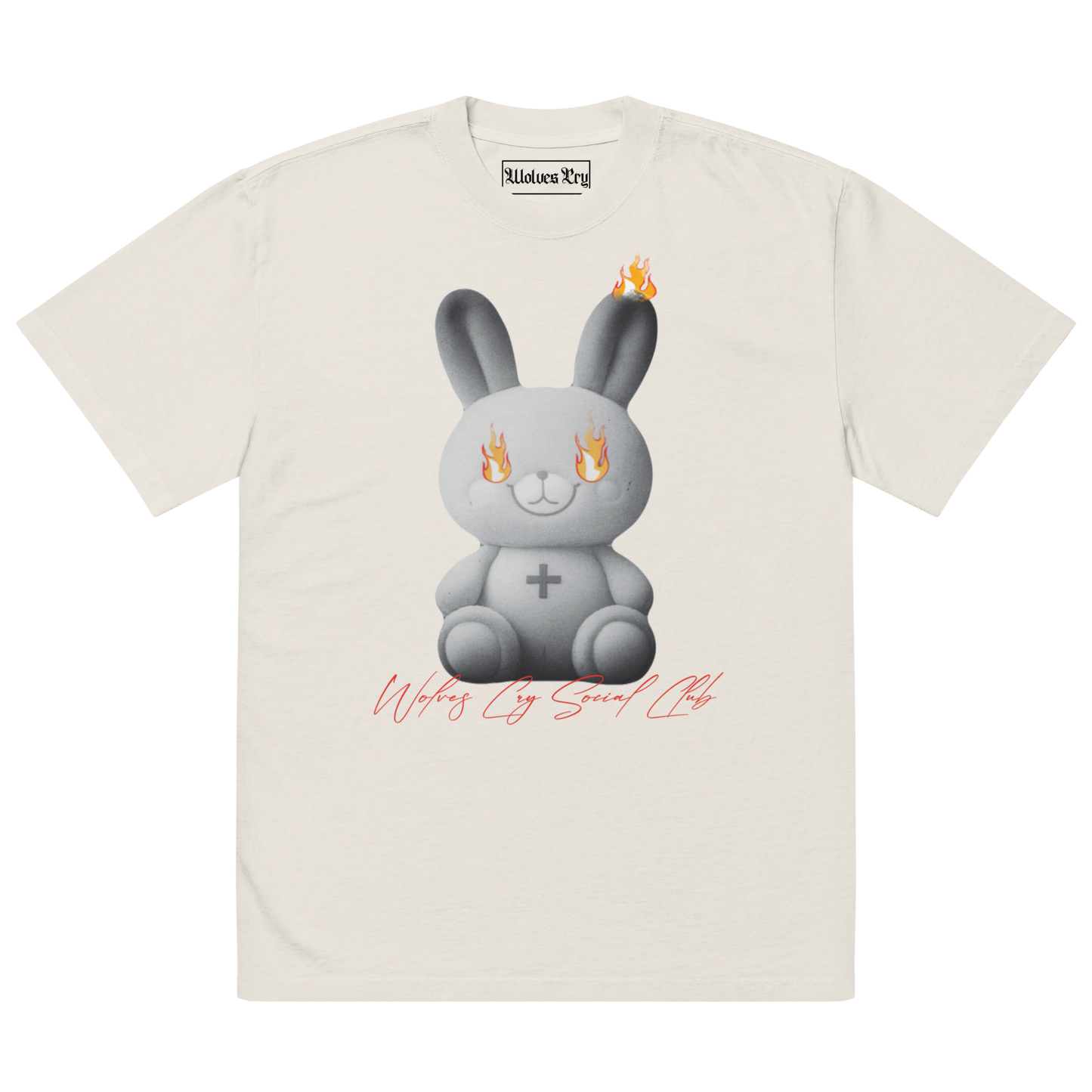 Front view of Wolves Cry Originals Oversized Teddy Tee in bone off-white, featuring a bold graphic of a teddy bear engulfed in flames, symbolizing resilience and nostalgia.