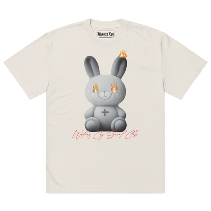 Front view of Wolves Cry Originals Oversized Teddy Tee in bone off-white, featuring a bold graphic of a teddy bear engulfed in flames, symbolizing resilience and nostalgia.