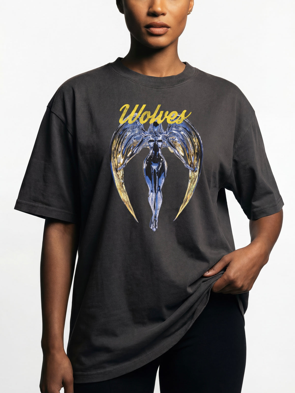 Model wearing the Wolves Cry Originals Angels oversized tee in vintage black photographed in studio lighting highlighting the heavyweight cotton and oversized streetwear fit.