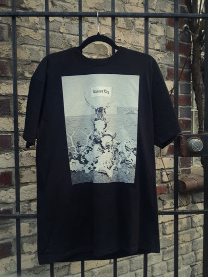 Wolves Cry Death Valley Tee in black hanging against an urban brick wall. Heavyweight cotton, monochrome graphic, designed for bold streetwear style