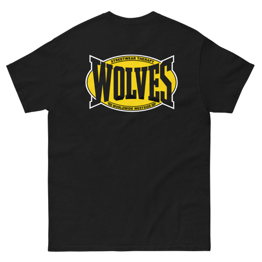 A black short-sleeve t-shirt shown flat against a white background, featuring a large graphic on the chest with the word 'WOLVES' in black over a yellow shape, plus smaller yellow and white text reading 'STREETWEAR THERAPY' and WORLDWIDE WESTSIDE