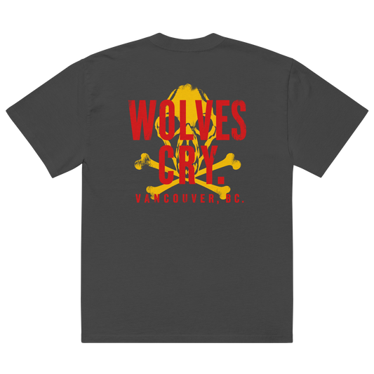 A dark gray crewneck t-shirt shown from the back, featuring a large graphic print with a yellow skull and crossbones behind red text that reads 'WOLVES CRY' and 'VANCOUVER, BC.' below it.